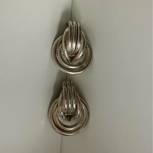 Statement earrings.    Silver plated metal c-large love knot clip on earrings